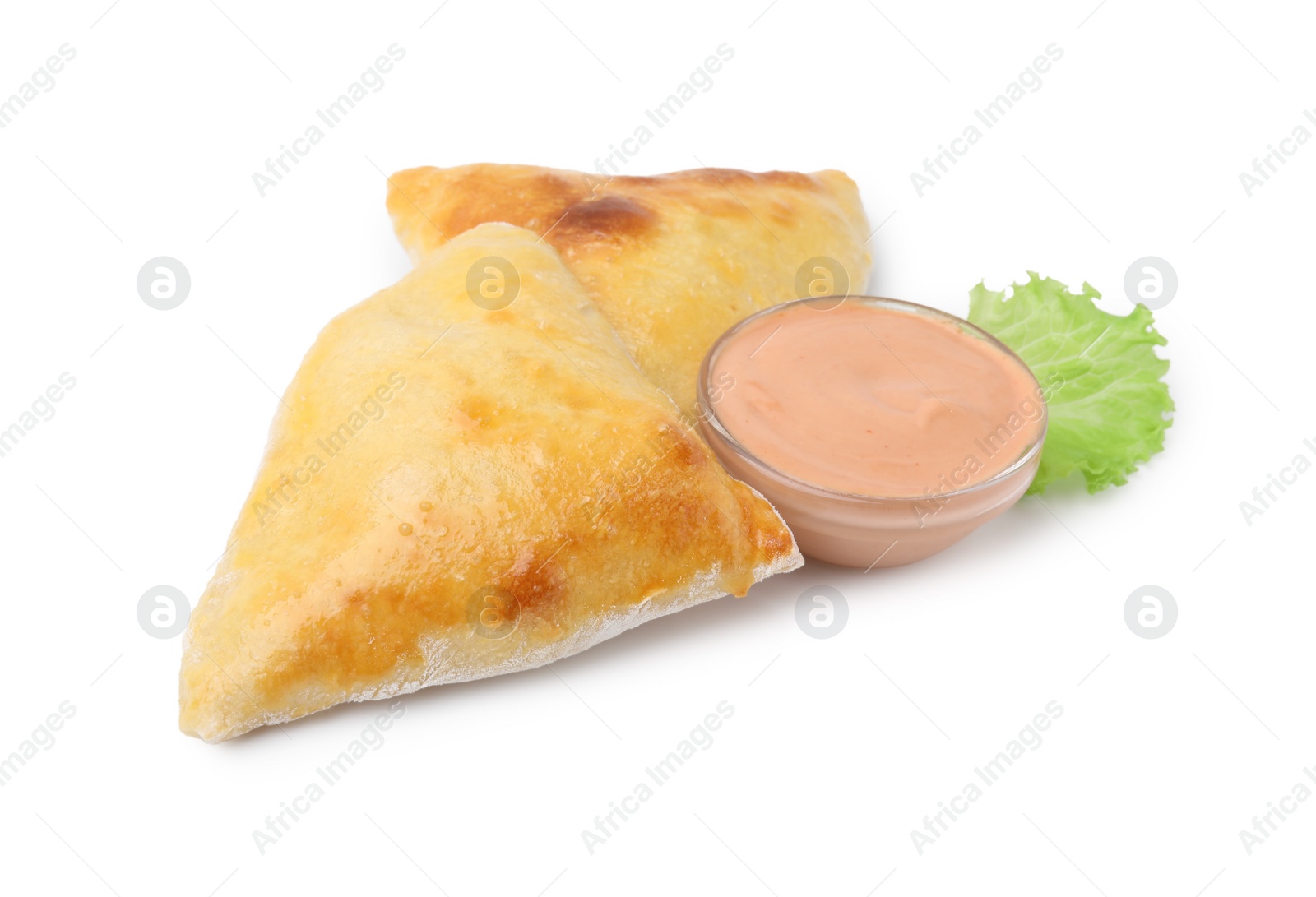 Photo of Delicious samosas, lettuce and sauce isolated on white