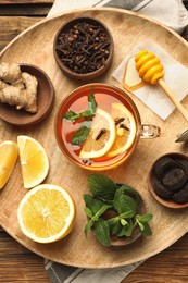 Photo of Tray with immunity boosting drink and ingredients on wooden table, top view