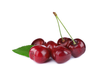 Photo of Tasty ripe red cherries with green leaf isolated on white