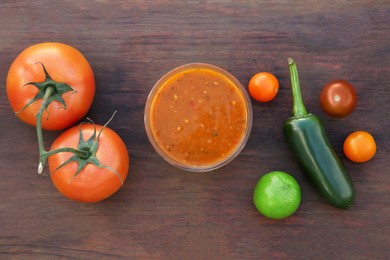 Photo of Tasty salsa sauce and ingredients on wooden table, flat lay