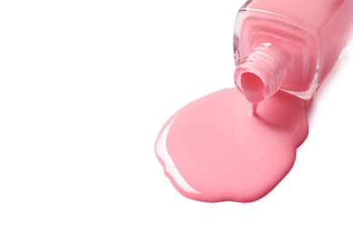 Photo of Spilled color nail polish with bottle on white background