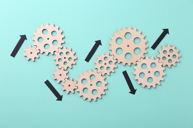 Photo of Business process organization and optimization. Scheme with wooden figures and arrows on light blue background, top view
