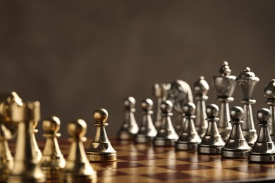Photo of Chessboard with game pieces on grey background
