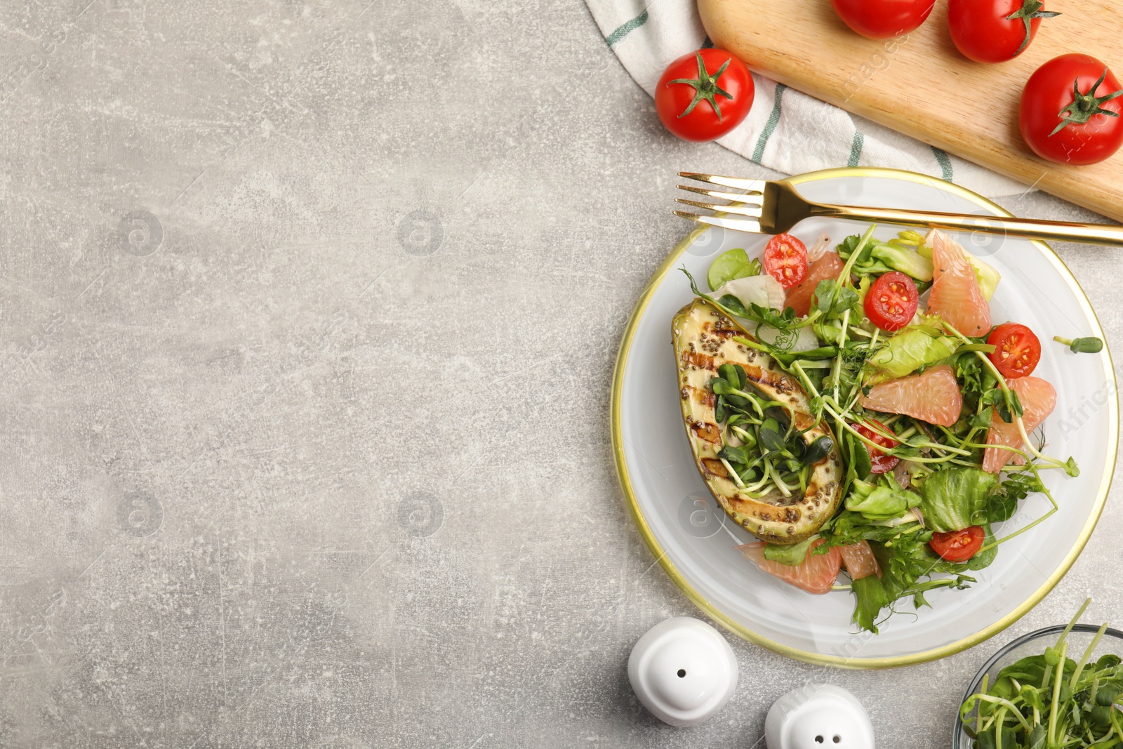 Delicious pomelo salad with grilled avocado served on light grey table, flat lay. Space for text Photo of Delicious pomelo salad with grilled avocado served on light grey table, flat lay. Space for text