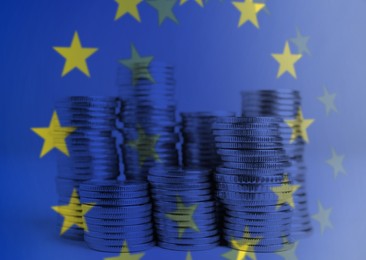 Image of Double exposure of European Union flag and coins on table, closeup view