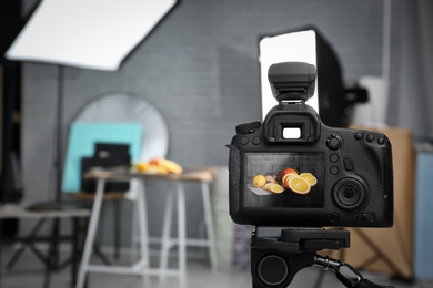 Photo of Professional camera on tripod in studio, closeup. Food photography
