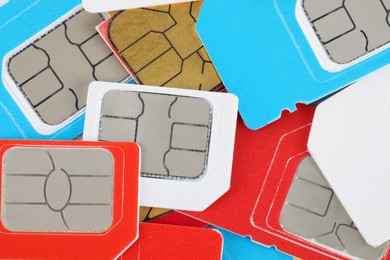 Photo of Different SIM cards as background, top view