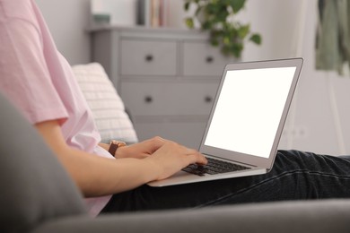 Photo of Woman with laptop on sofa at home, closeup