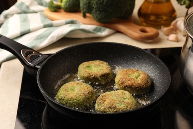 Photo of Cooking vegan cutlets in frying pan on stove