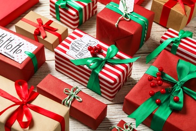 Photo of Different Christmas gift boxes on white wooden background