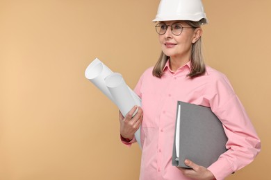 Photo of Architect in hard hat with drafts and folder on beige background, space for text