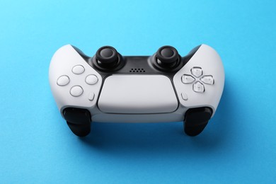 Photo of Wireless game controller on light blue background