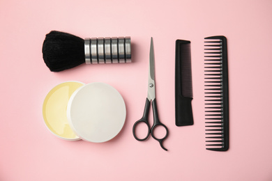 Photo of Professional hairstyling tools on pink background, flat lay