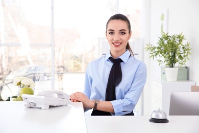Photo of Portrait of female receptionist at workplace in hotel