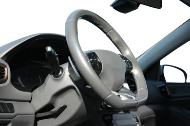 Image of Steering wheel and dashboard in modern car isolated on white