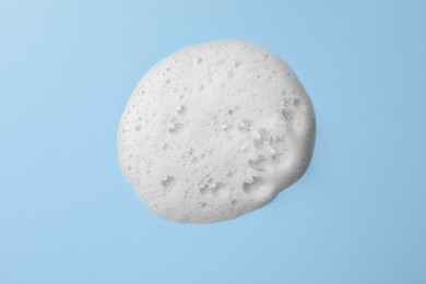 Photo of Foam sample on light blue background, top view
