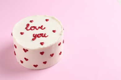 Photo of Bento cake with text Love You on pink table, space for text. St. Valentine's day surprise