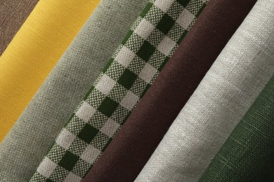 Photo of Many different fabrics as background, closeup view