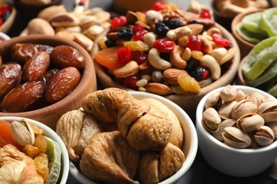 Photo of Composition of different dried fruits and nuts on table, closeup