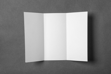 Photo of Blank brochure on gray background, view from above. Mock up for design