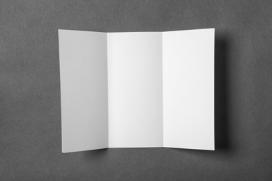 Blank brochure on gray background, view from above. Mock up for design