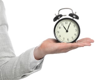 Businessman holding alarm clock on white background, closeup. Time management