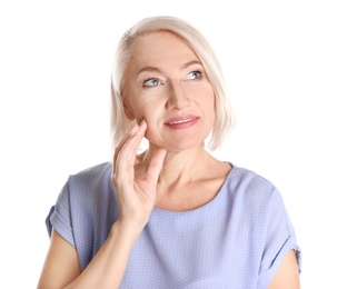 Portrait of charming mature woman with healthy beautiful face skin and natural makeup on white background