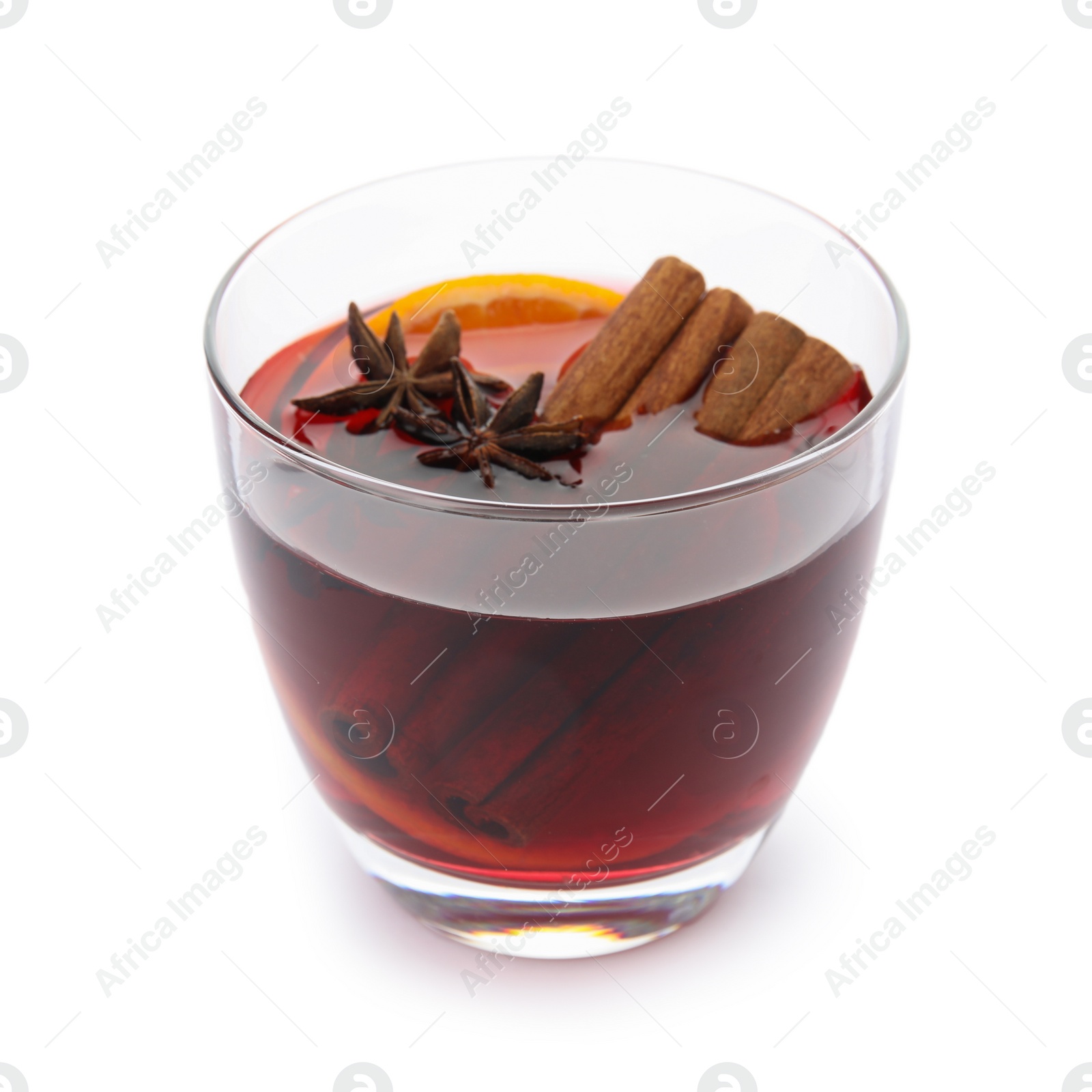 Photo of Glass of mulled wine with spices isolated on white