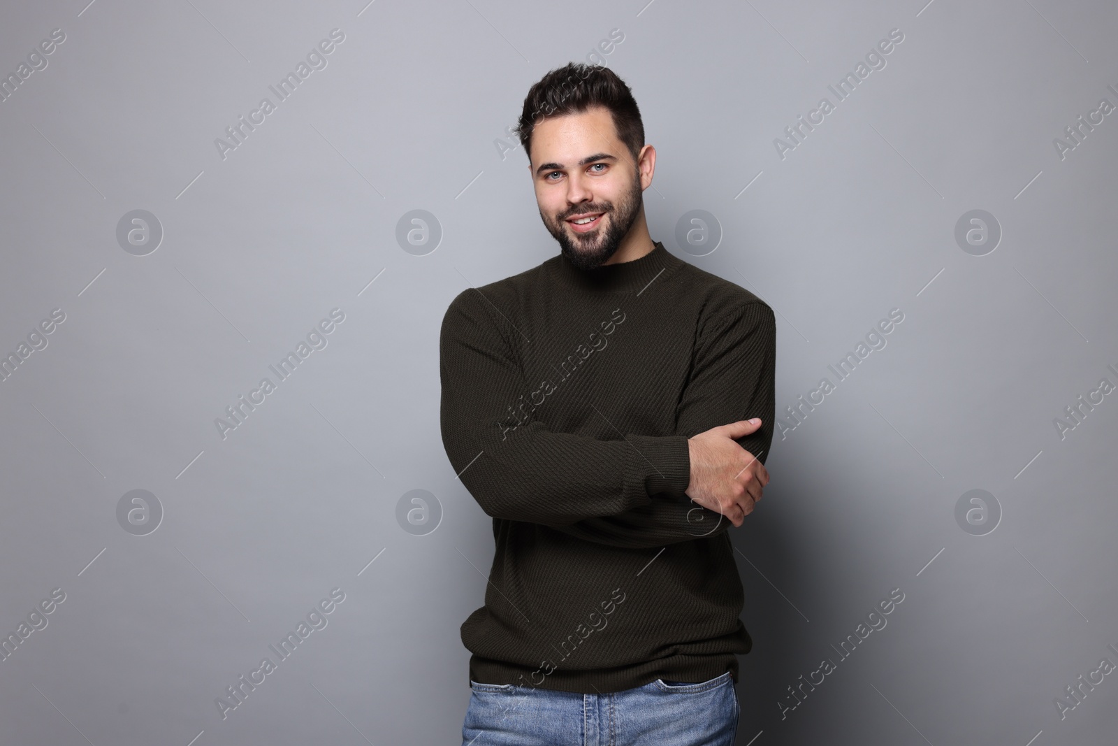 Photo of Happy man in stylish sweater on grey background