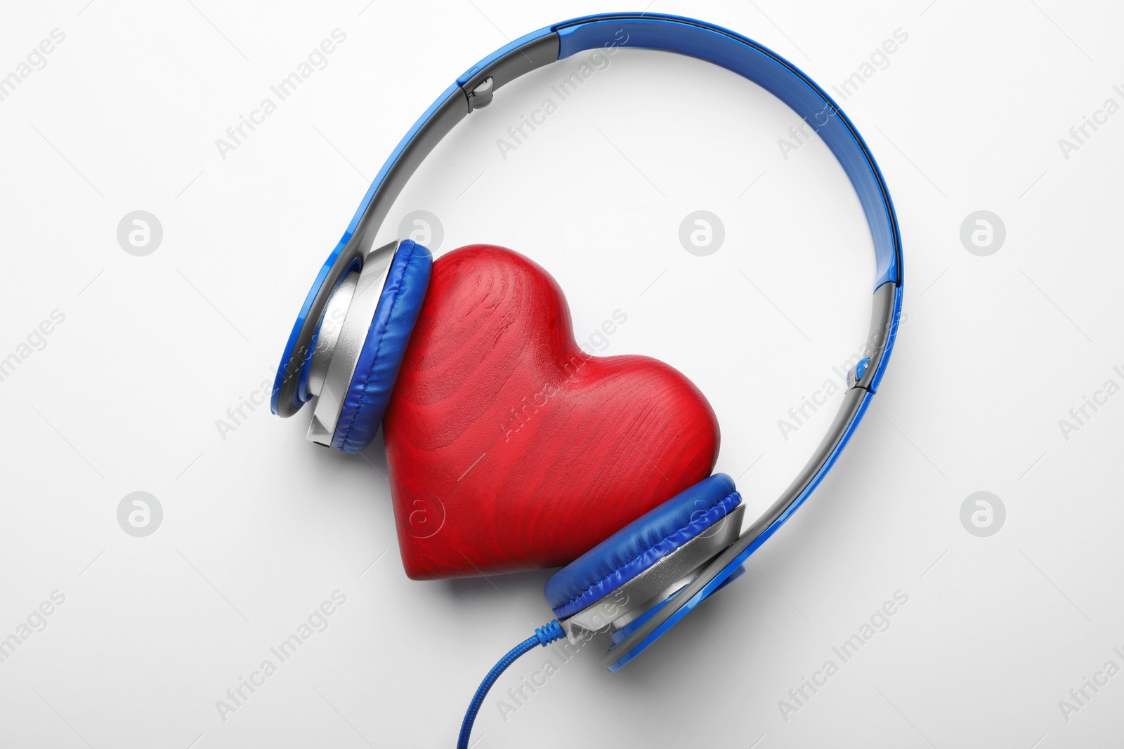 Photo of Decorative heart and modern headphones on white background, top view