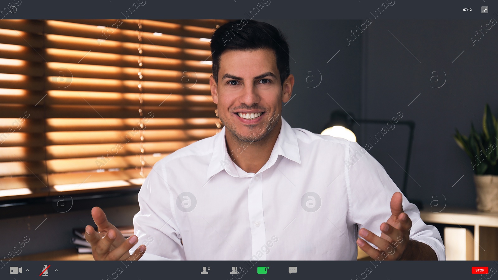 Image of Man communicating with coworkers from home using video chat, view through camera