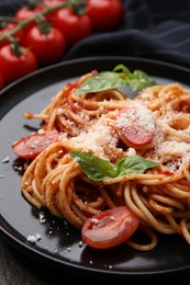 Photo of Tasty pasta with tomato sauce, cheese and basil on table, closeup