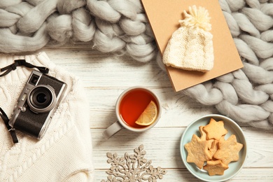 Photo of Flat lay composition with cup of hot winter drink on wooden background. Cozy season