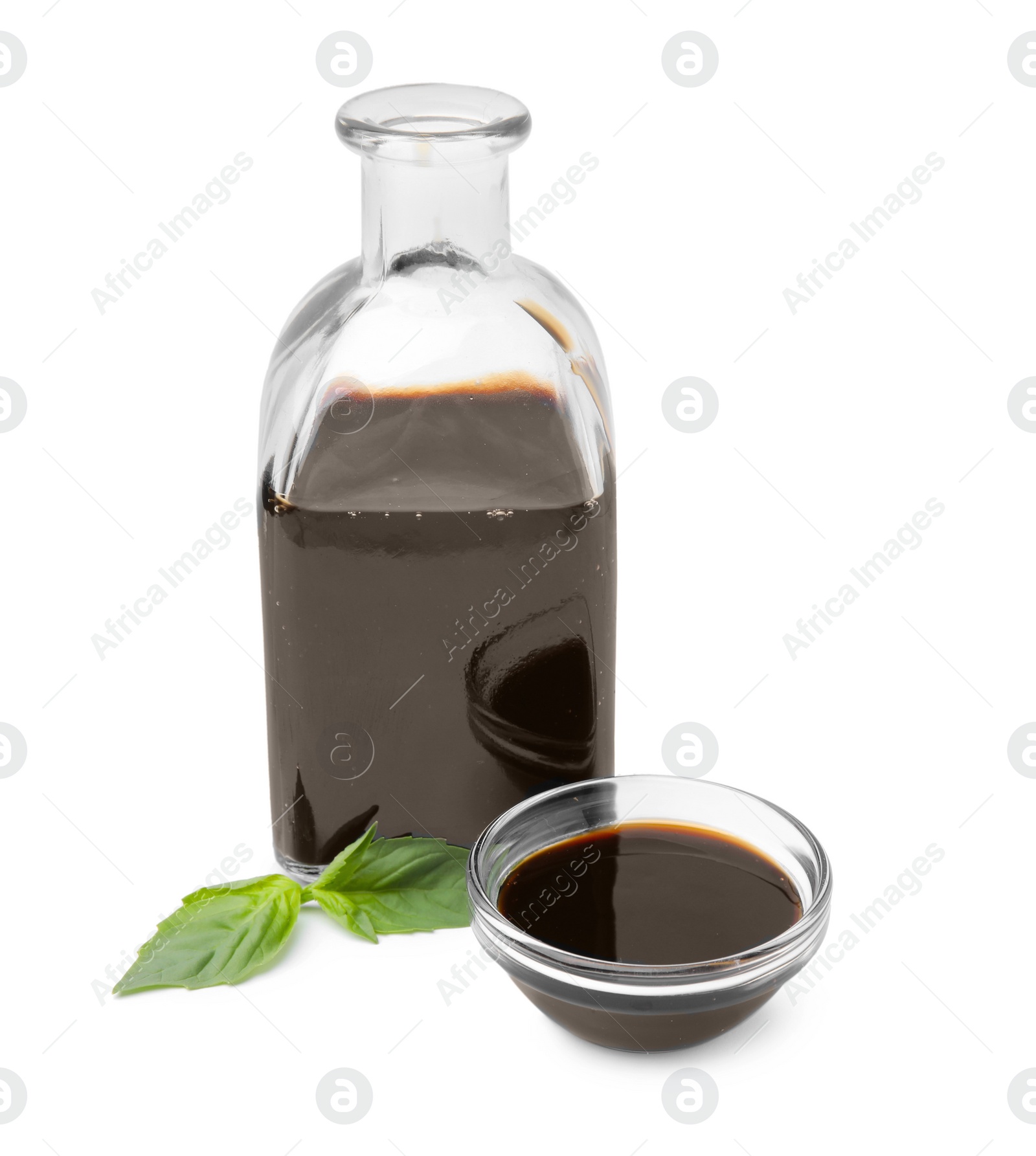 Photo of Organic balsamic vinegar and basil isolated on white