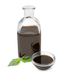 Photo of Organic balsamic vinegar and basil isolated on white