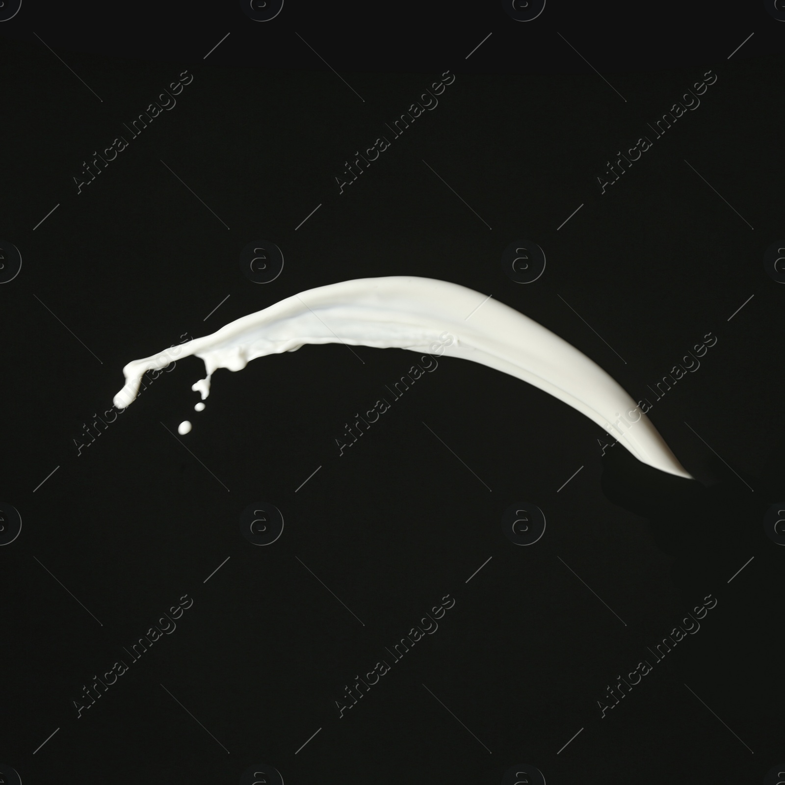 Photo of Splash of fresh milk on black background