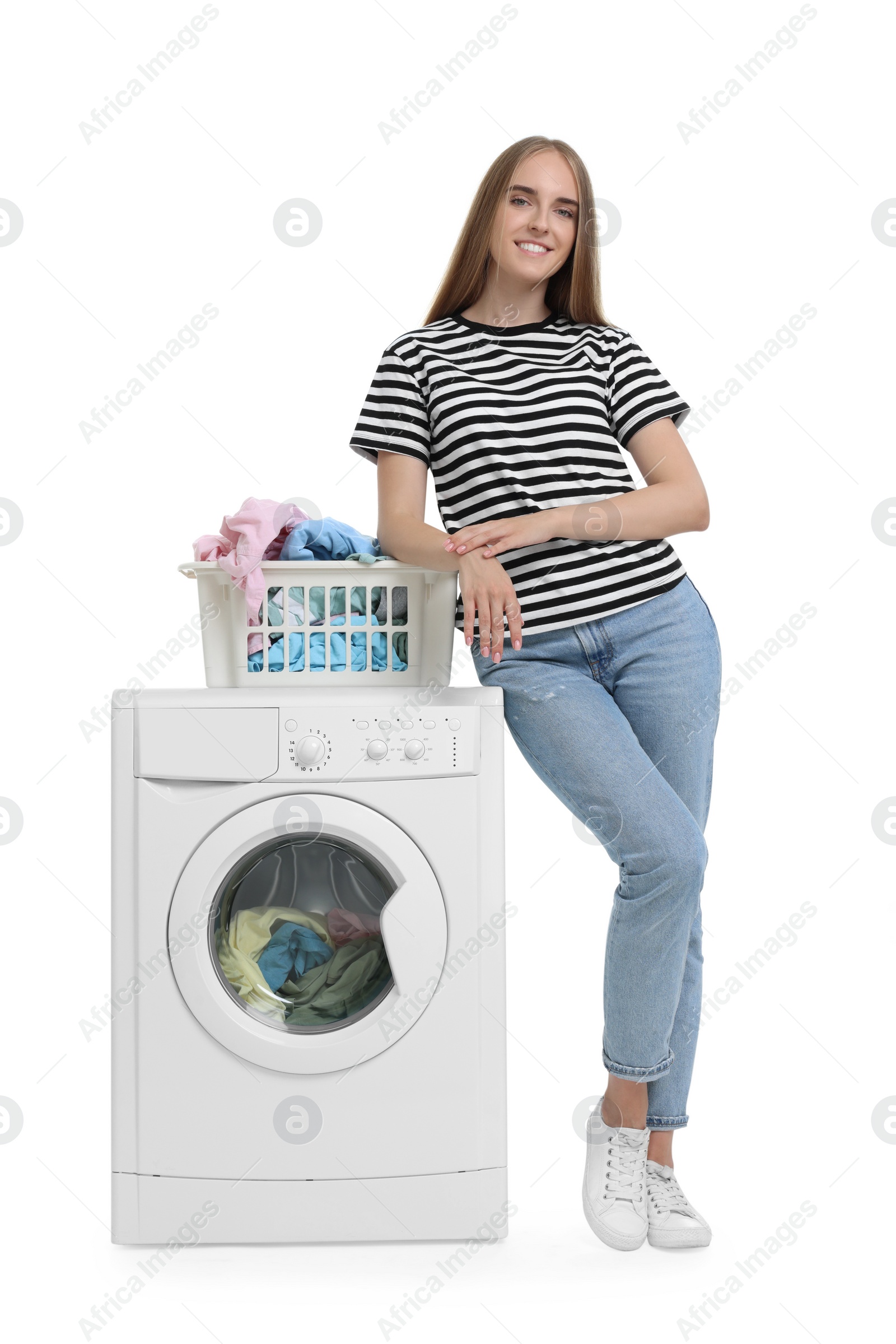 Photo of Beautiful young woman with laundry basket near washing machine on white background