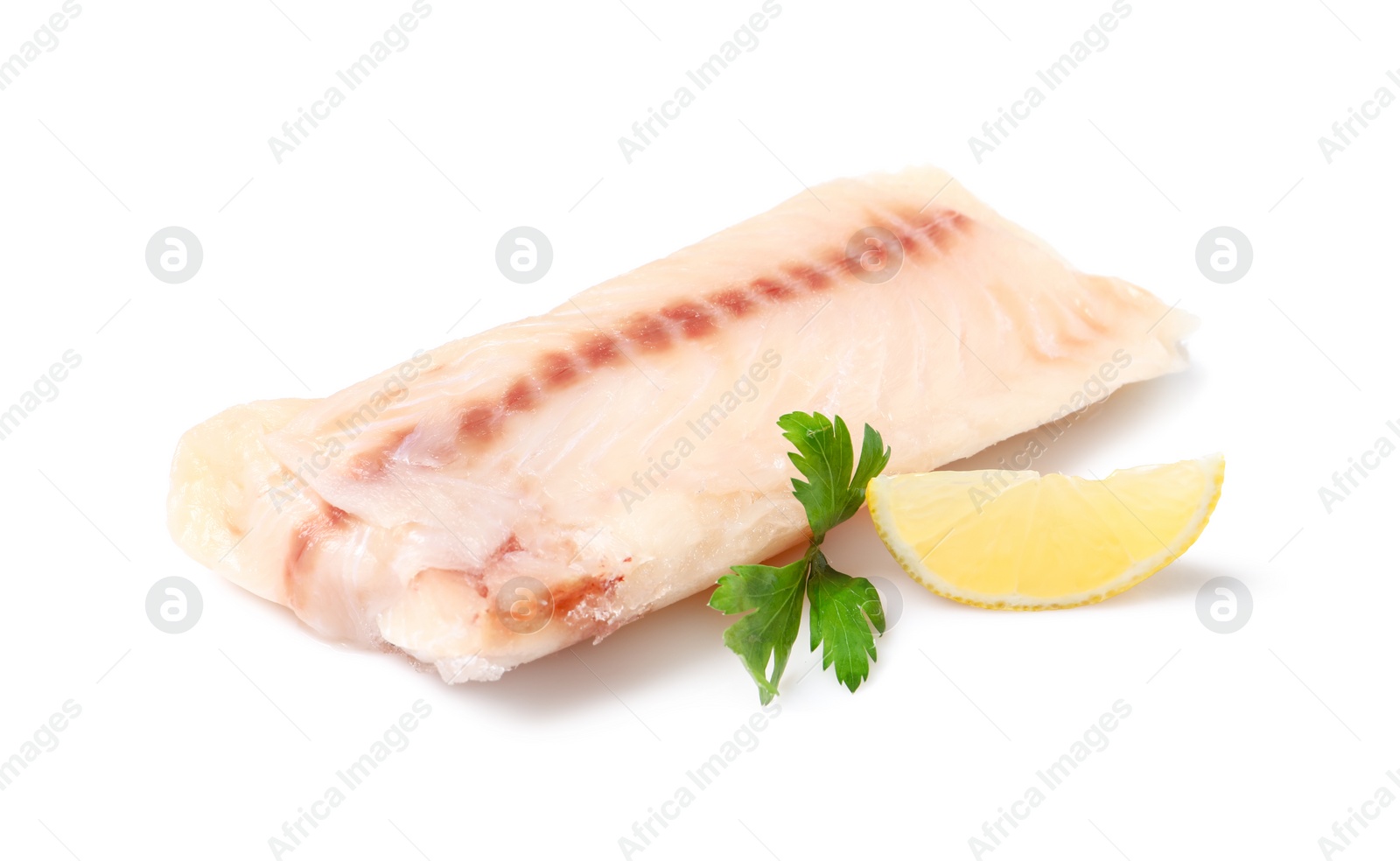 Photo of Pieces of raw cod fish, parsley and lemon isolated on white