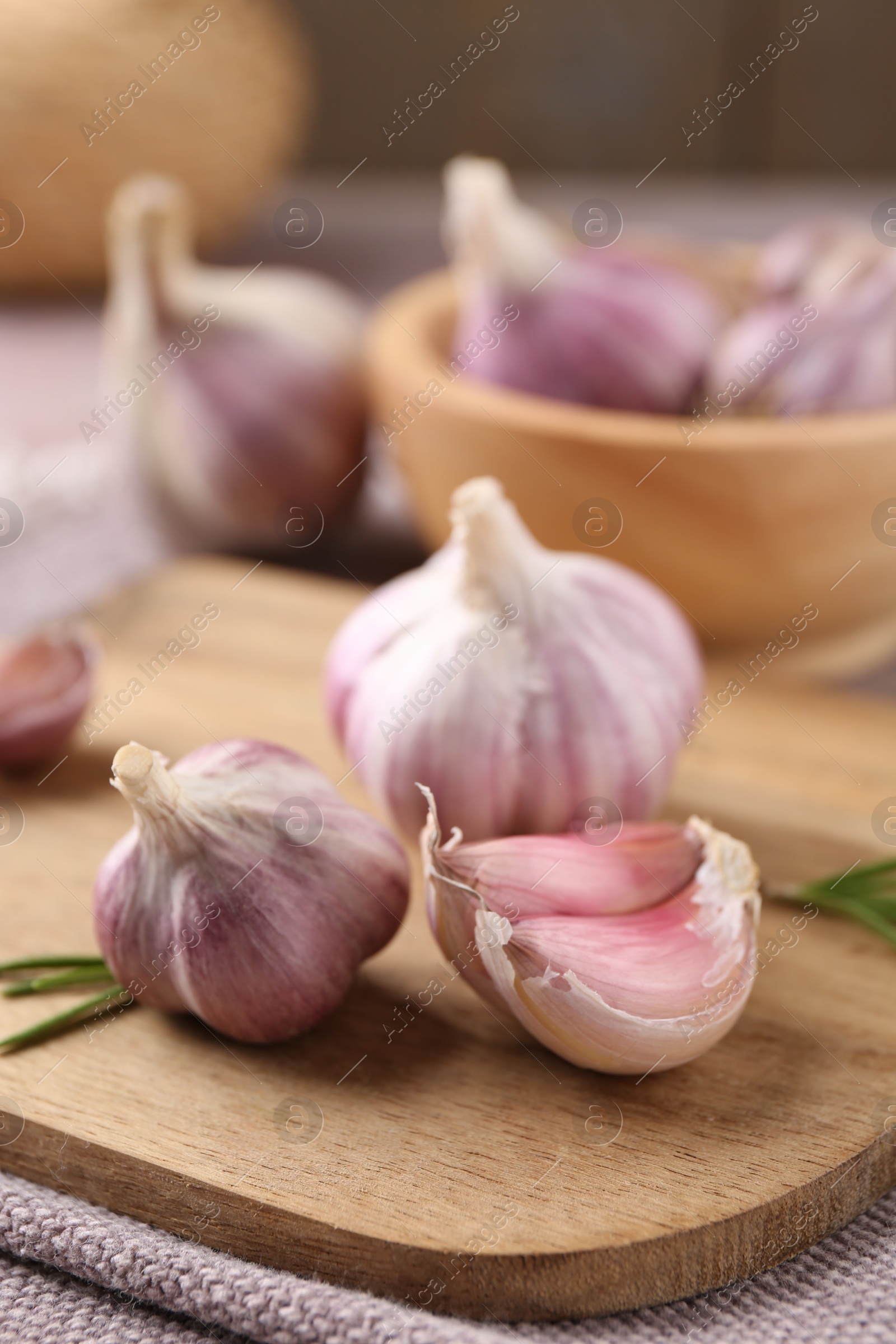 Photo of Bulbs and cloves of fresh garlic on table, closeup