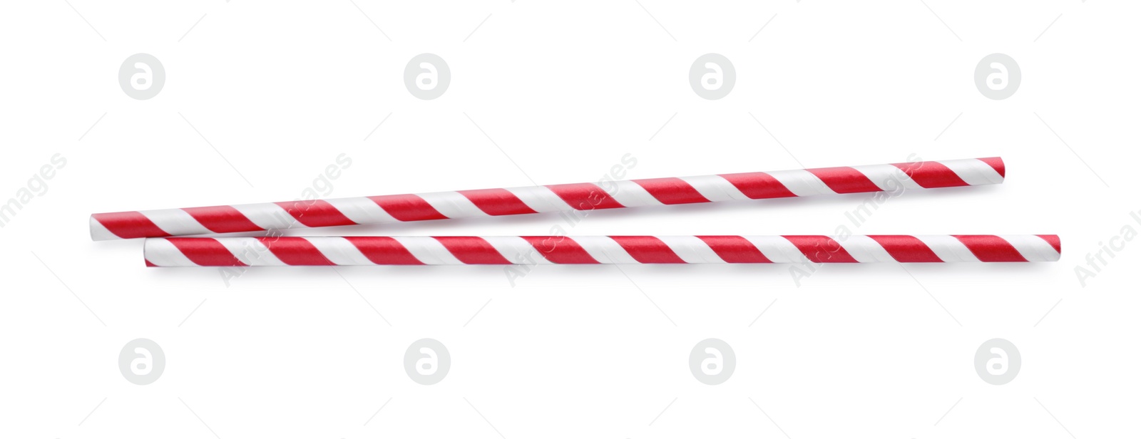 Photo of Striped paper cocktail straws on white background, top view