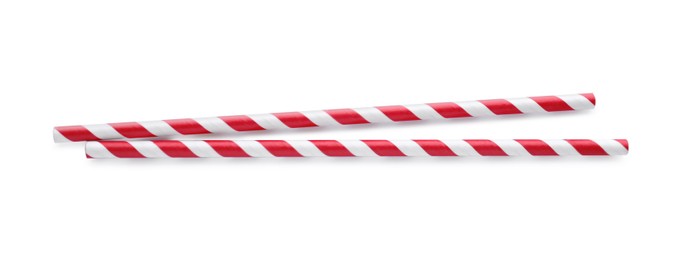 Photo of Striped paper cocktail straws on white background, top view