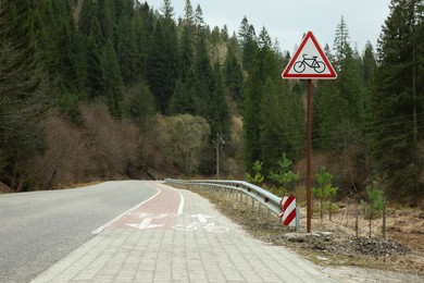 View on road with bilateral bike path near forest