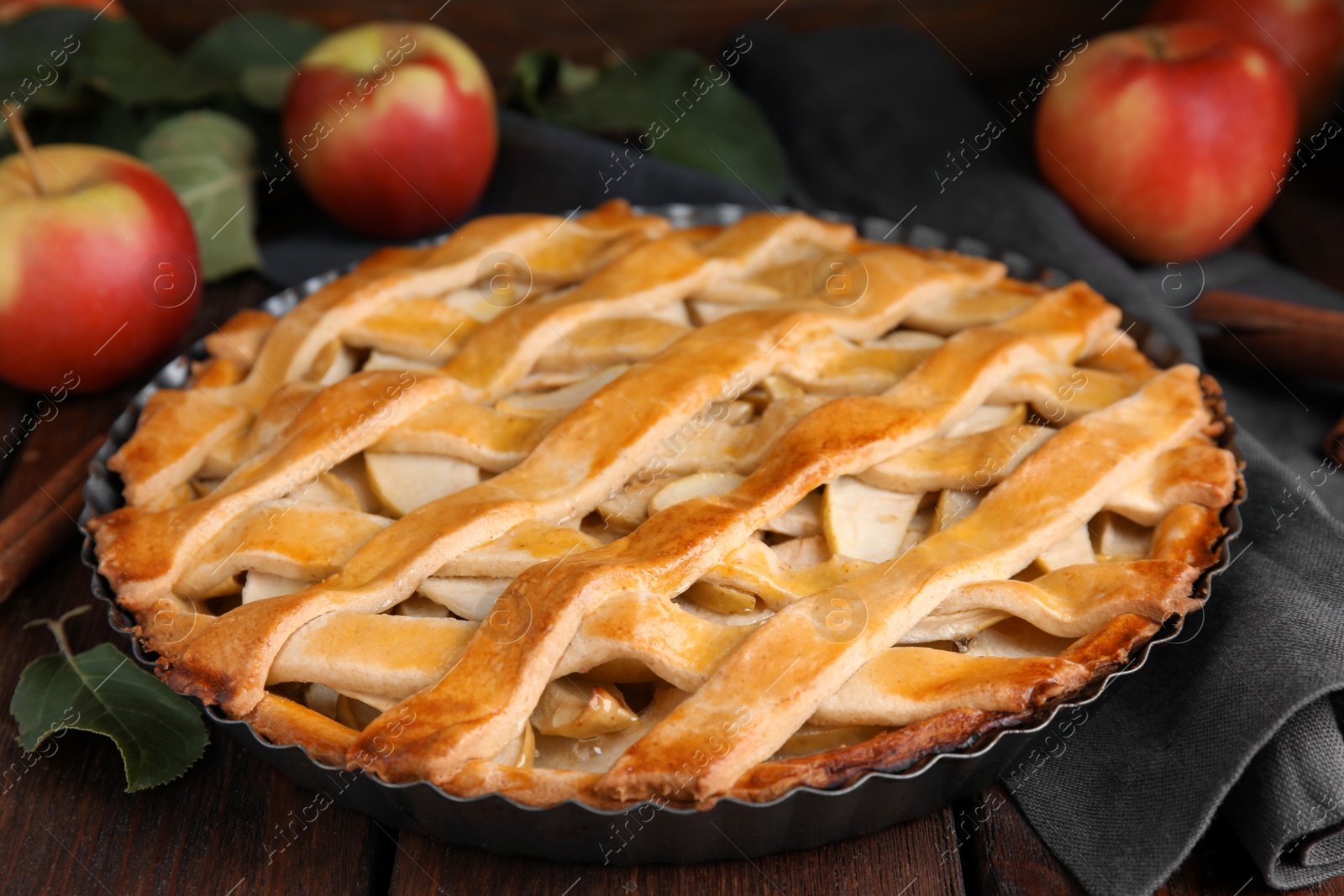 Photo of Delicious traditional apple pie on wooden table, closeup