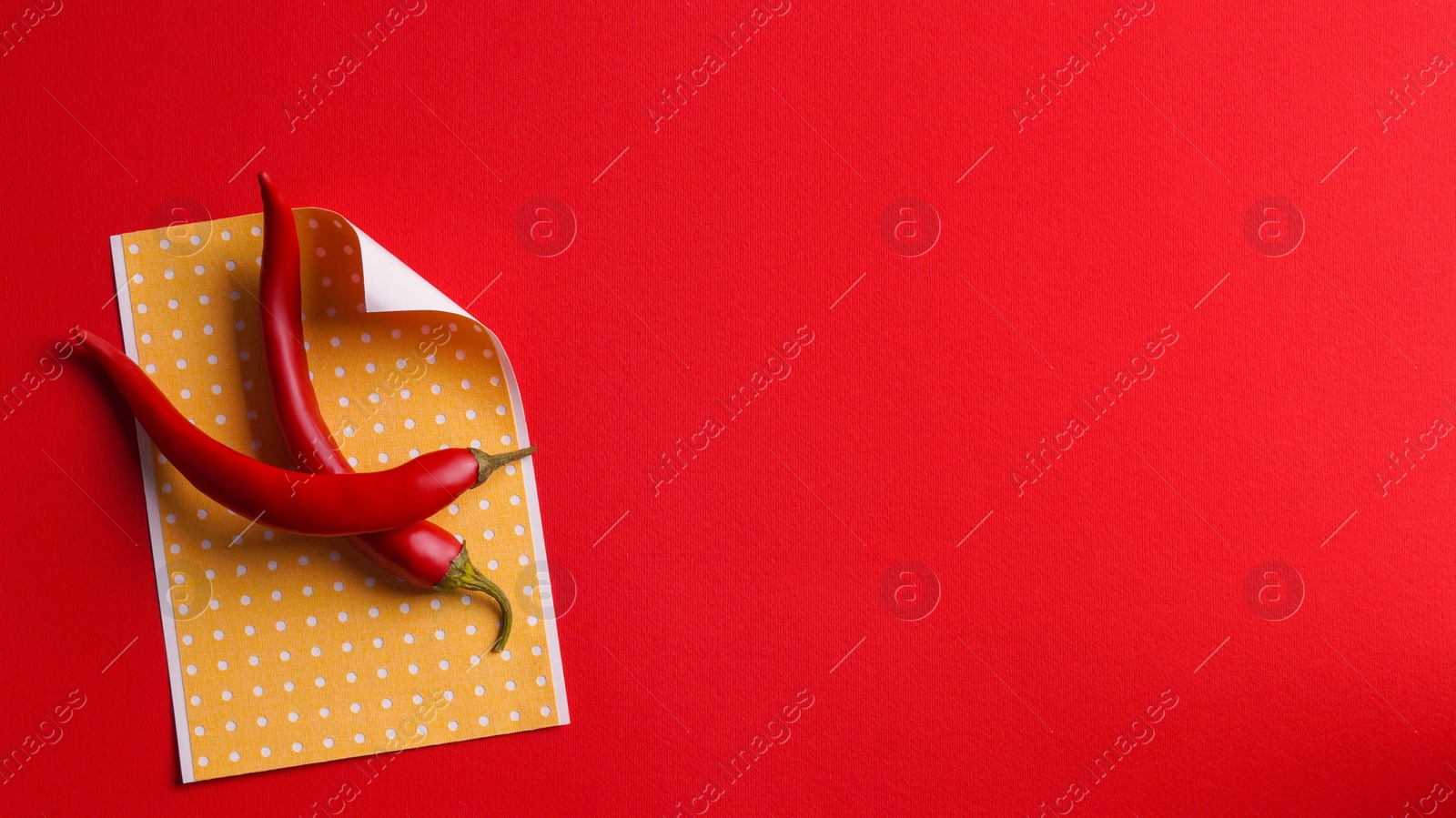 Photo of Pepper plasters and chili on red background, top view. Space for text