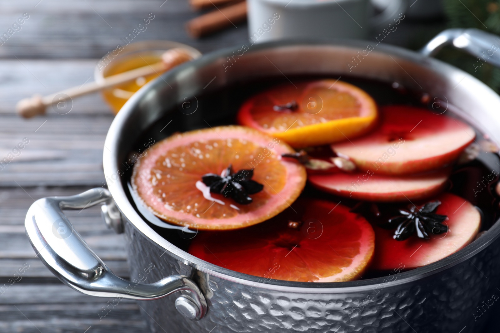 Photo of Delicious mulled wine on table, closeup view