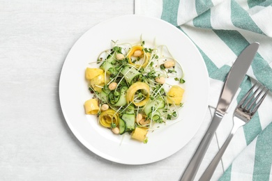 Photo of Delicious fresh carrot salad served on white table, flat lay