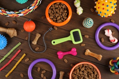 Photo of Flat lay composition with different pet goods on wooden background. Shop assortment