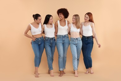 Group of beautiful young women on beige background