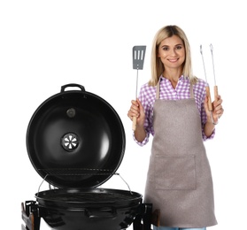 Photo of Woman in apron with barbecue grill and utensils on white background