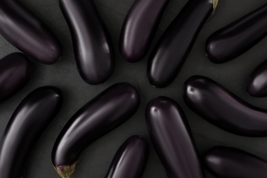 Raw ripe eggplants on black table, flat lay